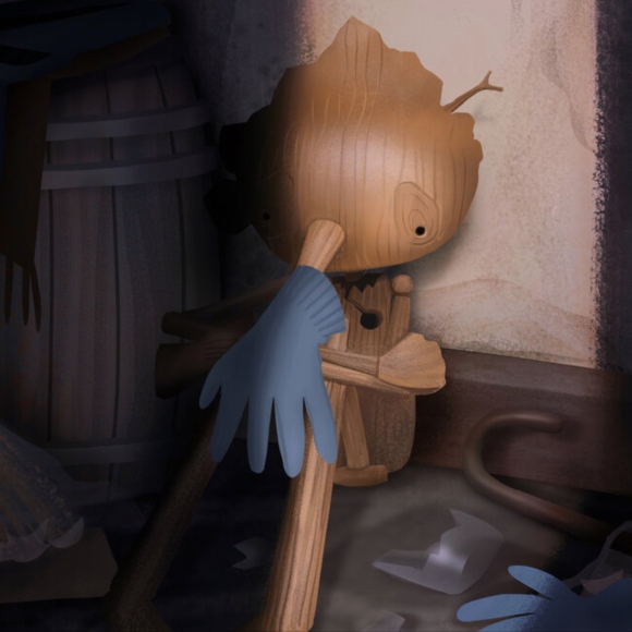 A VisDev painting by Jenn Ely for Guillermo del Toro’s Pinocchio showing the titular character sitting curled in on himself in a dark closet, a glove hanging from his long, wooded nose.
